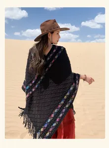 Bohemian ethnic style knitted poncho with colorful diamond patterns and fringe tassels.