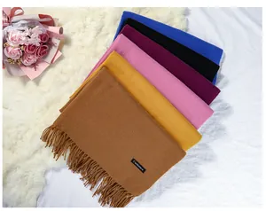 Selection of solid color imitation cashmere scarves with fringes and label detail