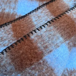Soft blue and brown checkered mohair scarf showing premium fuzzy texture and stitching