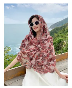 Model wearing a pink floral print bali yarn long shawl for beach sun protection