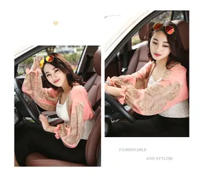 Detailed view of peach paisley chiffon sun protection shawl with elegant ruffle cuffs.