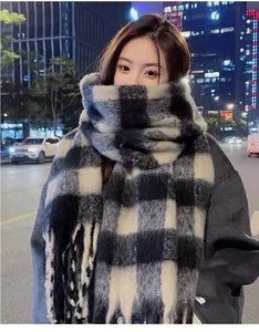 Asian model wearing a thick black and white mohair plaid scarf in winter city night