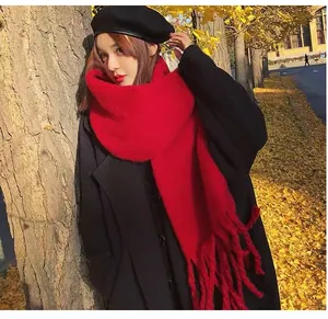 Fashionable solid red mohair scarf for women worn in an outdoor autumn setting