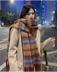 Cozy multi-color striped mohair-feel scarf worn by a model in a night city scene.