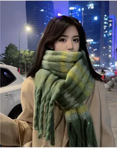 Stylish green and yellow checkered mohair-style scarf worn by a model in city night