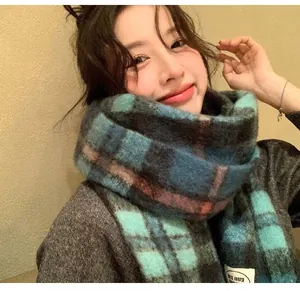 Thick mohair checkered winter scarf in teal blue plaid pattern worn by a model