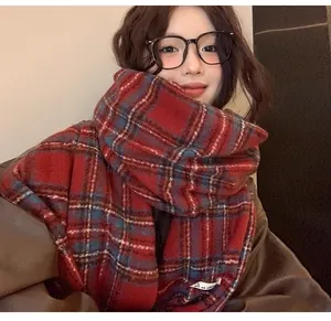 Close-up view of a woman wearing a red plaid cashmere scarf for cozy winter warmth