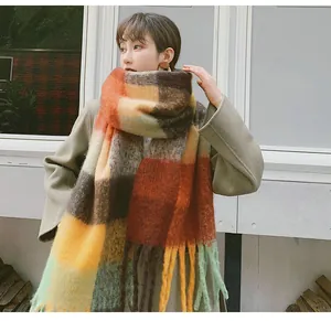 Detailed view of thick checkered mohair scarf featuring soft texture and stylish tassels