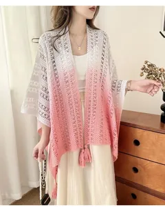 Detailed shot of elegant pink ombre crochet knit shawl with stylish fringe tassels