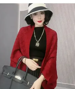 Detailed view of the red hollow diamond knitted shawl cardigan shown on an Asian model