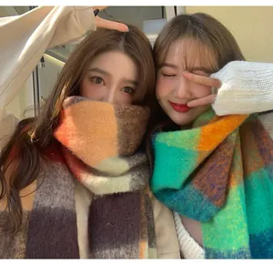 Close-up of soft thick mohair plaid scarves in warm autumn and winter colors.