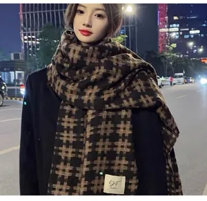 Winter warm cashmere-like scarf with a stylish grid pattern shown on a model at night
