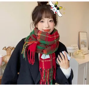 Close-up of a festive red and green plaid scarf with soft tassels for winter