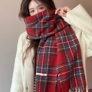 Close-up detail view of a warm red plaid tassel scarf worn by an Asian model in winter