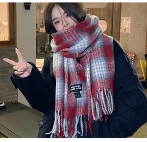 Detailed view of an Asian woman wearing an Angola red plaid imitation cashmere winter scarf