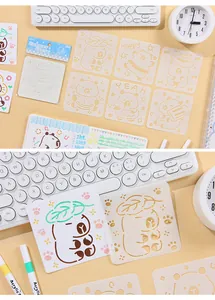 Close-up of cartoon bear drawing stencil set with colorful markers on a minimalist desk
