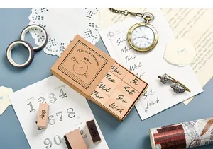 Close-up detail of a wooden weekday stamp set inside its minimalist kraft paper box
