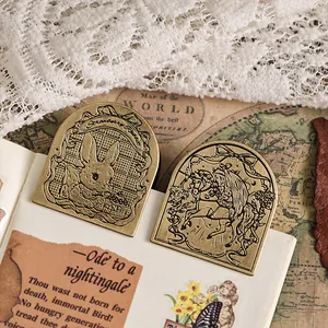 Vintage brass metal clips with retro rabbit and unicorn engravings for retro stationery