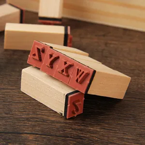 Vintage wooden alphabet stamp set with red rubber letters for DIY crafting and journaling