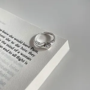 Detailed macro shot of a minimalist S925 silver adjustable ring with heart-shaped zircon