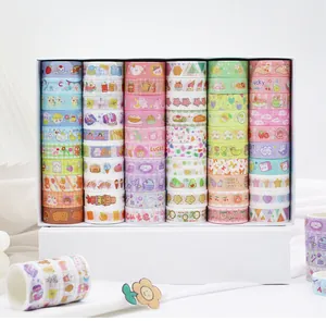 Large collection of cute cartoon washi tape rolls organized in a white gift box for journals