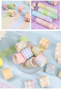 Detailed view of multiple plaid patterned washi tape rolls in pastel colors for DIY crafts