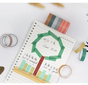 Creatief DIY-gebruik van een meerkleurige washi-tapeset op een pagina van een spiraalschrift