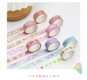 Macro detail of colorful cartoon washi tape rolls with cute rabbit and star patterns