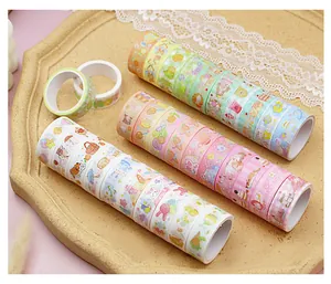 Close-up of assorted colorful washi tape rolls with cute cartoon patterns for crafts