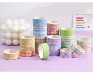 Detailed view of colorful plaid washi tape rolls for creative DIY journaling projects