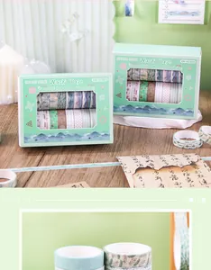Two boxes of forest style and watercolor series washi tape sets on a rustic wooden desk