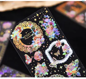 Detailed view of holographic rose journal stickers with 3D gold foil stamping effects