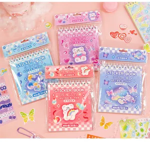 Detailed view of four cute cartoon spiral-bound sticker books for DIY journal decoration