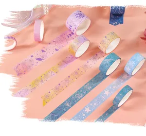 Detailed close-up of vintage constellation and rose pattern washi tape rolls