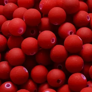 Macro detail of 8mm matte red acrylic spacer beads for DIY Christmas jewelry crafts