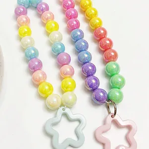 Macro view showing iridescent AB acrylic beads and colorful star-shaped pendants.
