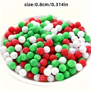 Close-up of 8mm Christmas style red, white and green acrylic spacer beads in a white bowl