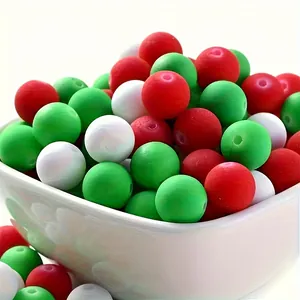Macro view of 8mm Christmas red, white, and green acrylic spacer beads in a white bowl