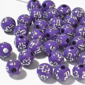 Macro detail of 8mm purple acrylic beads featuring silver cross pattern for DIY