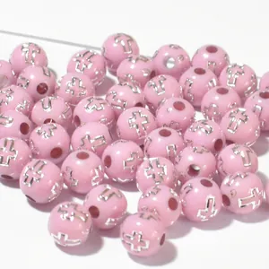 Detailed macro view of 8mm pink acrylic round beads featuring metallic silver cross pattern