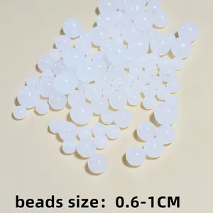 Macro view of white acrylic jelly round beads in mixed sizes for DIY jewelry crafts