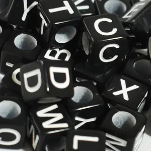 Macro detail of 6mm black square acrylic alphabet beads for DIY jewelry making and crafts