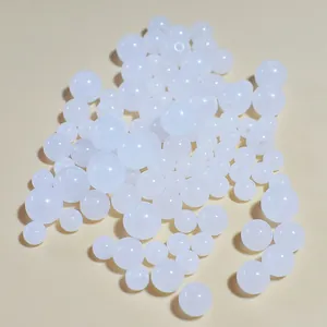 Close-up of white translucent acrylic jelly beads for DIY jewelry making in mixed sizes