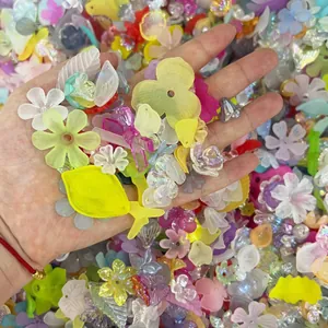 High-quality close-up of colorful iridescent acrylic flower and leaf beads for DIY jewelry.