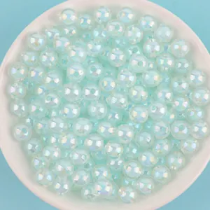 Macro detail of 8-10mm light blue AB iridescent acrylic beads for DIY jewelry crafting