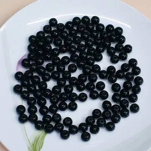 Close-up of black acrylic round beads for DIY jewelry and clothing accessories
