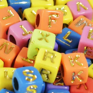 Close-up detail of 6mm colorful acrylic square letter beads with gold engraved letters for DIY