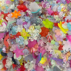 Close-up of mixed iridescent acrylic flower and leaf beads for DIY jewelry making.