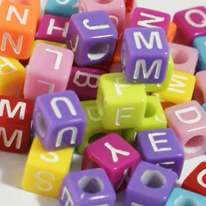 Macro shot of 6mm colorful acrylic alphabet square beads for DIY craft jewelry making.