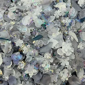 Assorted iridescent and frosted acrylic flower and leaf beads for DIY jewelry making.
